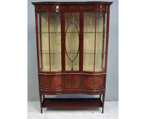 An early 20th century Sheraton style Display Cabinet, inlaid mahogany, the shaped top with moulded edge and dentil cornice ov