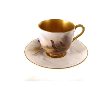 A Royal Worcester cabinnet cup and saucer, having hand painted pheasant design, heightened with gilt, marked 9141 to base, AF