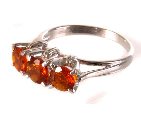 A 9ct white gold and fire opal dress ring, the three round cut orange stones set in high claw mount on white gold band, size 