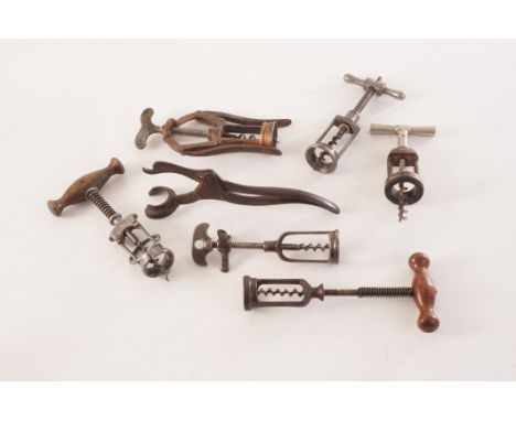 A collection of antique and vintage mechanical corkscrews, including The Patent Lever, a Columbus example, plus several other