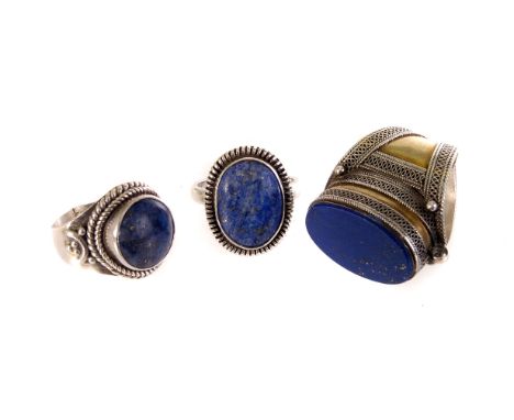 Three various vintage lapis lazuli dress rings, one Middle Eastern example in white and gold metal, and two in white metal (3