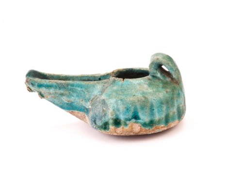 A Seljuk period Persian oil lamp, typical Kashan style, and with turqoise glaze, 13th - 14th century