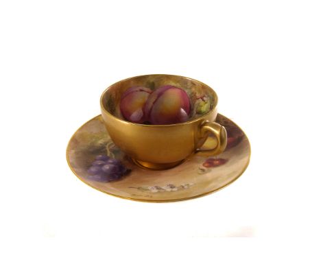 A Royal Worcester cabinnet cup and saucer, having hand painted fruit design with signature Ricketts to saucer, with gilt desi