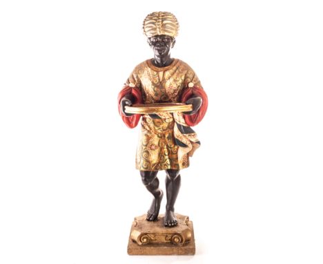 A vintage carved wooden blackamoor butler figure,  the gesso and well painted figure holding circular tray, supported on a he