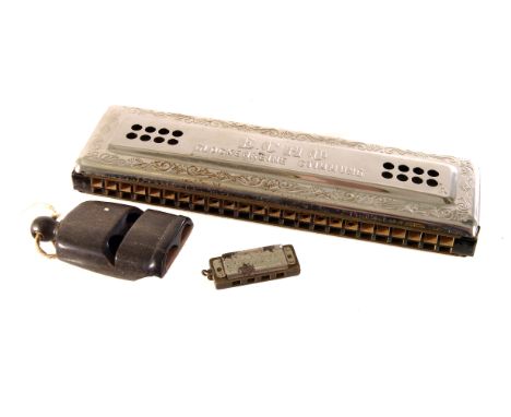 A Hohner 'Echo' harmonica, in box, together with a miniature Hohner harmonica and a wooden dual whistle (3)