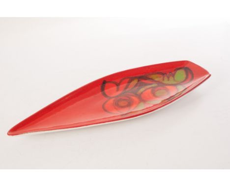 A Poole pottery Aegean dish, in the shape of a petal, having red ground and orange, green and black decoration, marked to bas
