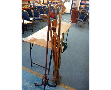 A collection of walking sticks and crops in stand, including an antler handle example, together with a firescreen stand (parc