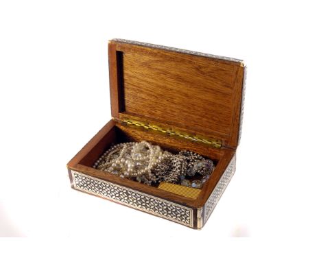 A small selection of costume jewels, including two cultured pearl necklaces, glass beads, a yellow metal lighter etc