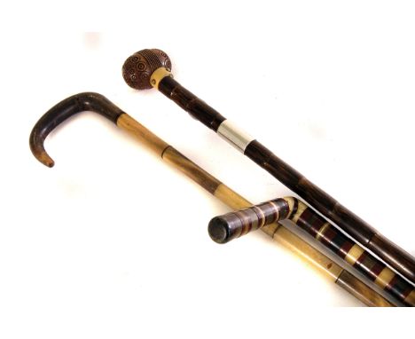 A mixed horn walking cane, together with a coquilla nut walking cane with white metal collar and a dwarf stick (3)