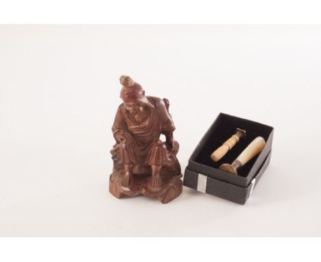 A 1920s Chinese root carving of a fisherman, together with a a bone handled seal press, plus a abalone handled example (3)