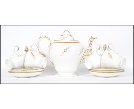 A 19th century Victorian Staffordshire tea service having white glaze with gilt decorated borders. The set comprising teapot,