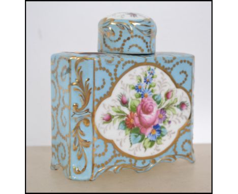 A 19th century Regency continental caddy of ceramic form being decorated with blue ground and foliate spray panel to centre. 