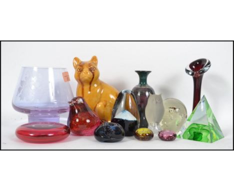 A good group of studio glass paperweights and other items to include a cranberry glass Wedgwood bird paper weight, a Caithnes