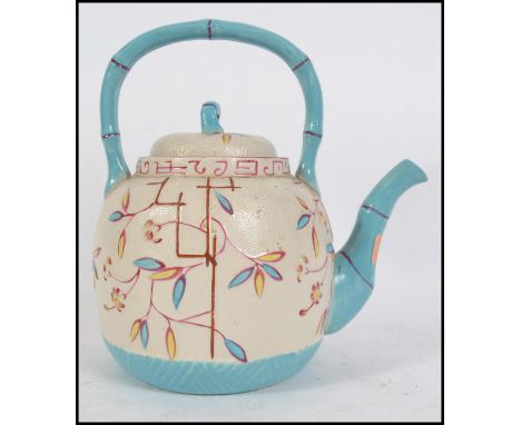 A 19th century Barr Flight ? porcelain teapot of large form in cream glaze with blue banded details and colourful glazed flec