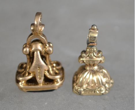 2 9ct gold intaglio seal pendants, each with inset stones to base, black and clear. Both with rococo style settings having ba