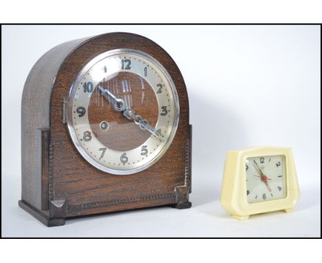 A vintage 20th century oak cased eight day mantle clock together with a retro travel clock&nbsp;