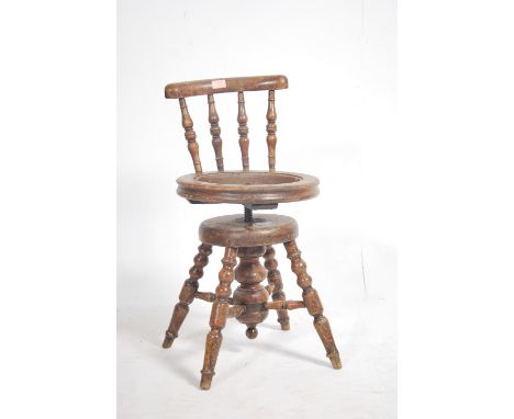 A Victorian Industrial clerks swivel chair in mahogany. Bobbin turned spindle supports with circular seat ( requires upholste