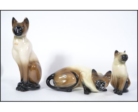 A set of 3 vintage Staffordshire large ceramic siamese cat figurines by Trentham pottery. One with original label intact. Mea