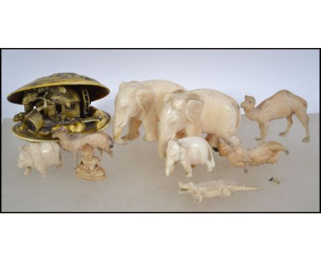 A collection of vintage ivory and bone items to include carved elephants and other animals please see images. Tallest measure