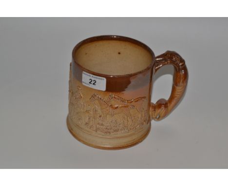 A 19th century Derbyshire brown saltglazed stoneware mug, in relief with with a fox hunting scene, the handle as a greyhound,