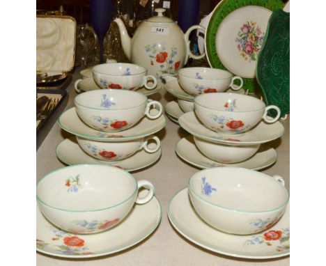 A Czechoslovakian ten-setting tea service, printed with poppies and country flowers on an oatmeal ground, mint green banding,