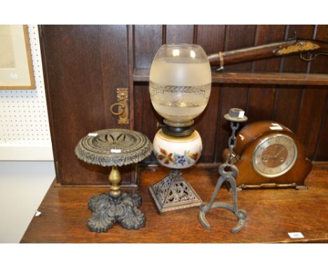 A brass and cast iron trivet; an iron candlestick in the form of blacksmiths tools; a Victorian oil lamp; an Indonesian hardw