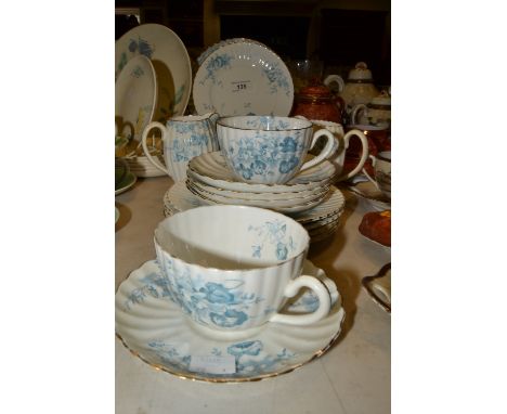 A Staffordshire part tea service, printed with blue flowers, gilt edged 