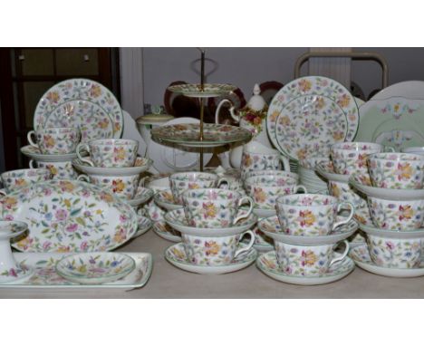 A Minton Haddon Hall pattern tea and breakfast service, comprising of  a five-tier cake stand, a set of three milk jugs, a ta