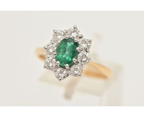AN 18CT GOLD EMERALD AND DIAMOND RING, designed and an oval cut emerald, approximate emerald carat weight 0.70ct, prong set w