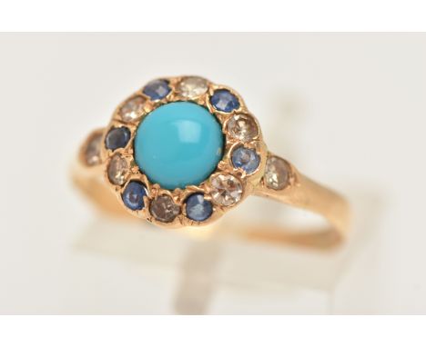 AN EARLY 20TH CENTURY 18CT GOLD GEM SET CLUSTER RING, of a circular form, set with a central blue stone cabochon, in a surrou