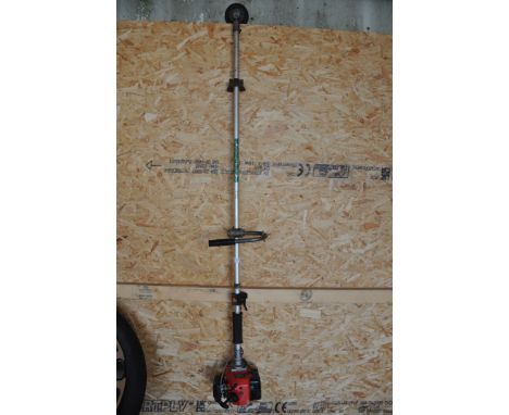 A KAWASAKI TG24 PETROL STRIMMER (condition report: engine turns but not tested any further)