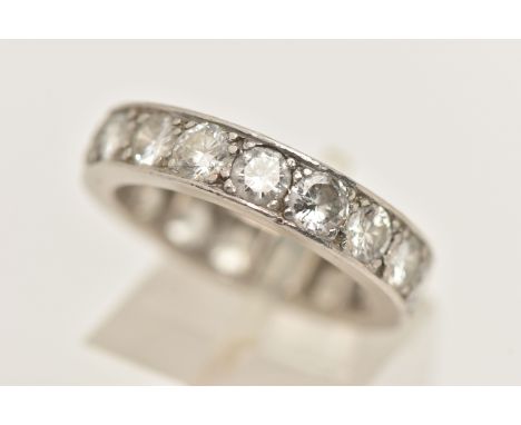 A WHITE METAL DIAMOND FULL ETERNITY RING, set with approximately seventeen round brilliant cut diamonds, measuring approximat
