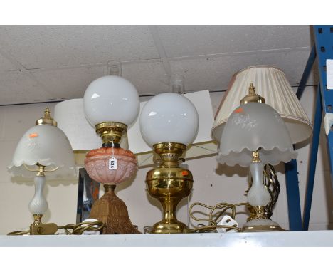 A GROUP OF TABLE LAMPS AND OIL LAMPS, to include two oil lamps: one with a pink-red glass reservoir, stamped Eltex, each with