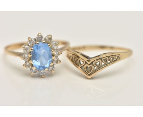 TWO 9CT GOLD RINGS, the first an oval cluster ring, set with a central oval cut light blue stone and colourless cubic zirconi