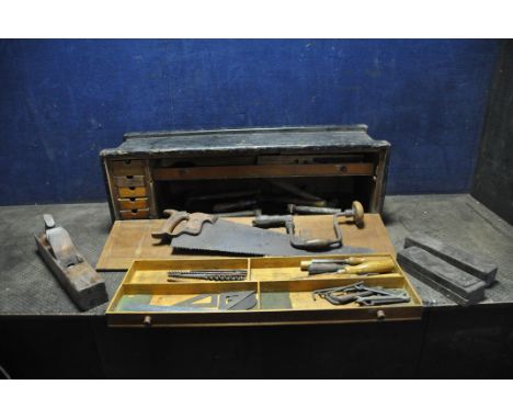 A VINTAGE CARPENTERS TOOLCHEST WITH SEVEN INTERNAL DRAWERS and containing tools including a repaired combination square, a Br