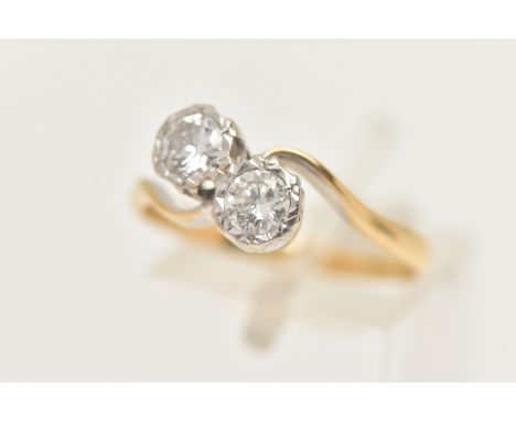 A TWO STONE DIAMOND RING, a toi et moi design ring, two round brilliant cut diamonds in a white metal illusion setting, appro