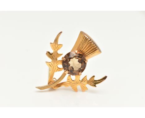 A 9CT GOLD THISTLE BROOCH, set with a circular cut smoky quartz in a five claw setting, fitted with a brooch pin and safety c