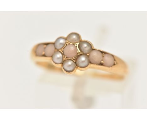 AN EARLY 20TH CENTURY CLUSTER RING, a floral design cluster, set with six seed pearls and five cabochon coral stones, yellow 