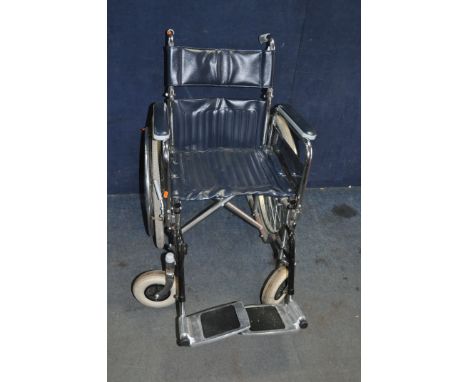 A WHEELCHAIRS UK FOLDING WHEELCHAIR with two footrests