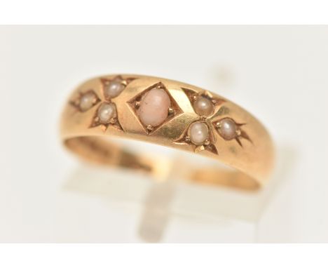 AN 18CT GOLD CORAL AND SEED PEARL RING, a yellow gold band ring prong set with an oval cabochon coral, flanked with six seed 