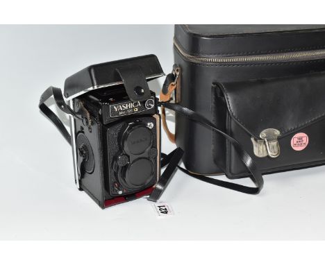 A YASHICA MAT-124 G CAMERA AND CARRY BAD mounted within its case fitted with a Yashinon 1:35 f=80mm lens, with a leather carr