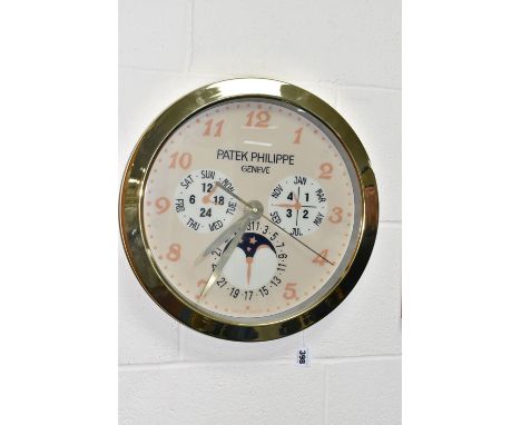A DISPLAY WALL CLOCK with a printed clock face marked 'Patek Philippe Geneve Swiss Made' with printed month and day dials, th