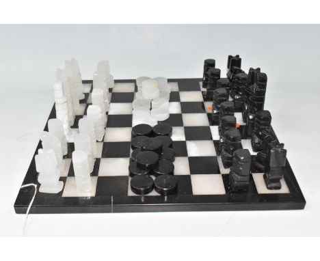 A BLACK AND WHITE ONYX 'ABSTRACT AZTEC' CHESS SET with thirty-two chess pieces on a matching board, with twenty-four pieces o