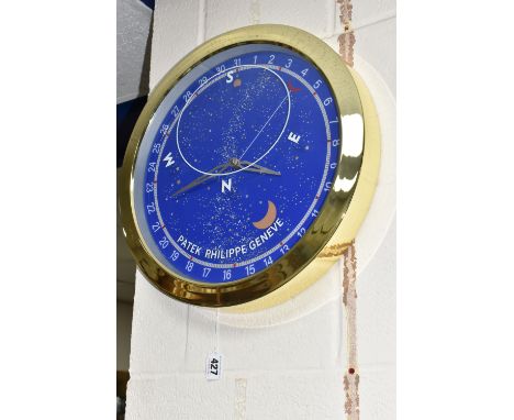 A DISPLAY WALL CLOCK, printed 'Patek Philippe Geneve', the face printed with Arabic numerals 1-31, printed second hand and a 