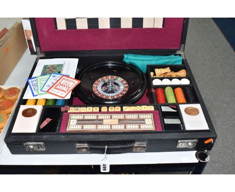 A K &amp; C LTD BOX SET OF TABLE GAMES comprising a roulette wheel, dominoes, chess pieces, draughts pieces, cribbage, two pa