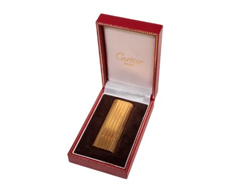 CARTIER: A GOLD PLATED CIGARETTE LIGHTER with reeded decoration, marked 'Cartier Paris No 2036B', in its original Cartier cas