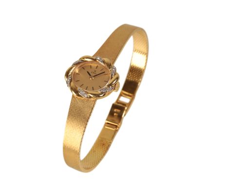 EBEL: AN 18CT GOLD LADY'S BRACELET WATCH with manual wind movement, the gold dial with gold baton numerals and dark blue stee