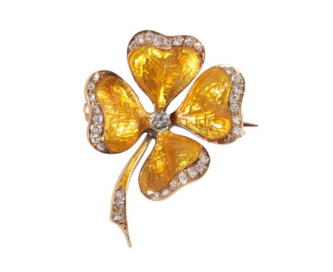 A GUILLOCHE ENAMEL AND DIAMOND CLOVER LEAF BROOCH each leaf and stem edged with old-cut diamonds on a yellow guilloche enamel