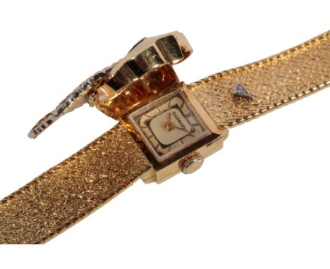 GARRARD: AN 18CT GOLD LADY'S BRACELET WATCH with manual wind movement, the silver dial with gold baton numerals and gold hand