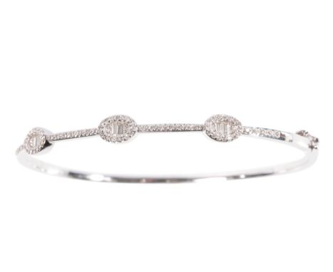 A DIAMOND HINGED BANGLE round and baguette-cut diamonds, half set on unmarked white metal, approx 11grams total weight